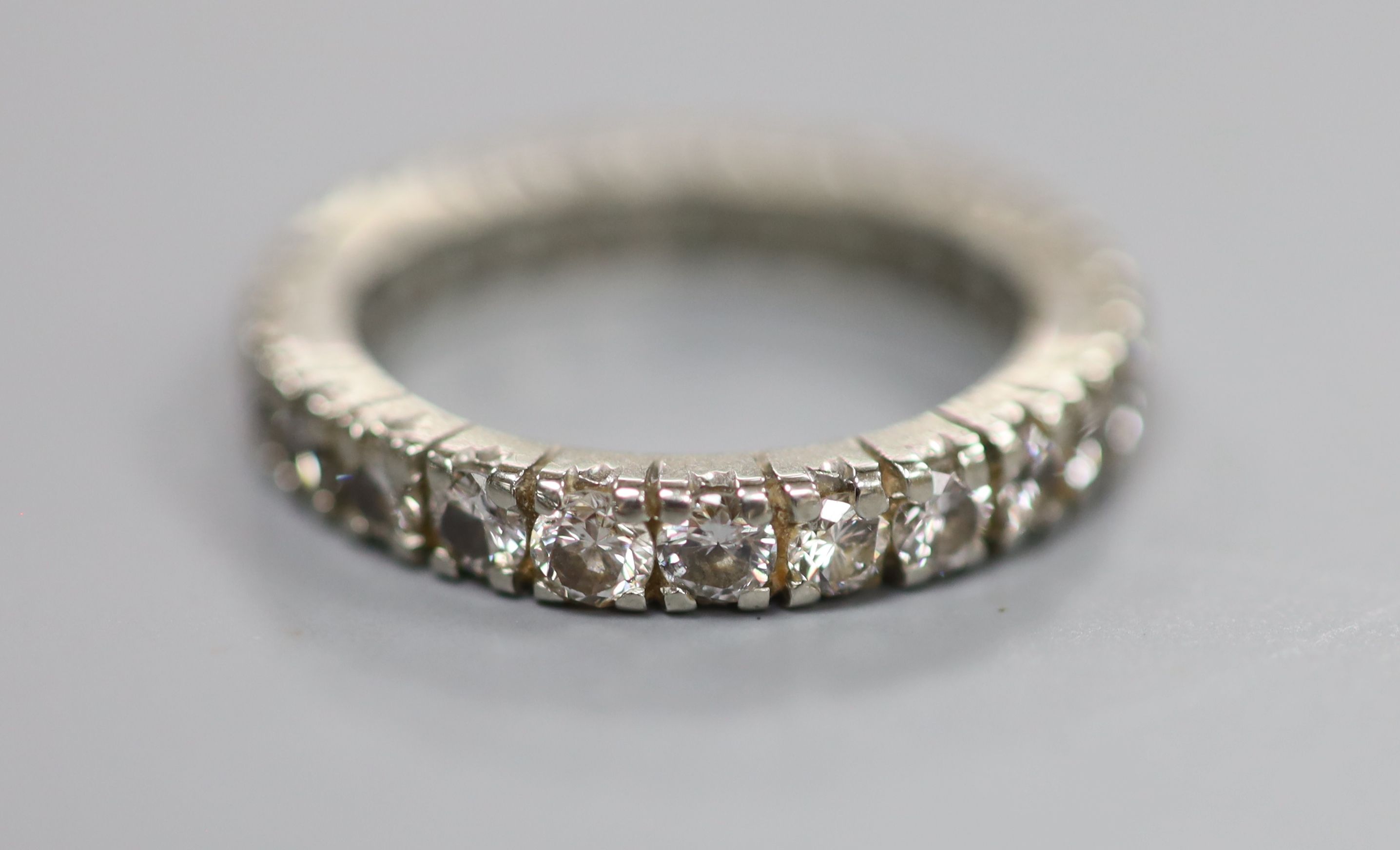 A 750 white metal and diamond set full eternity ring, set with twenty four round brilliant cut stones, size L/M,